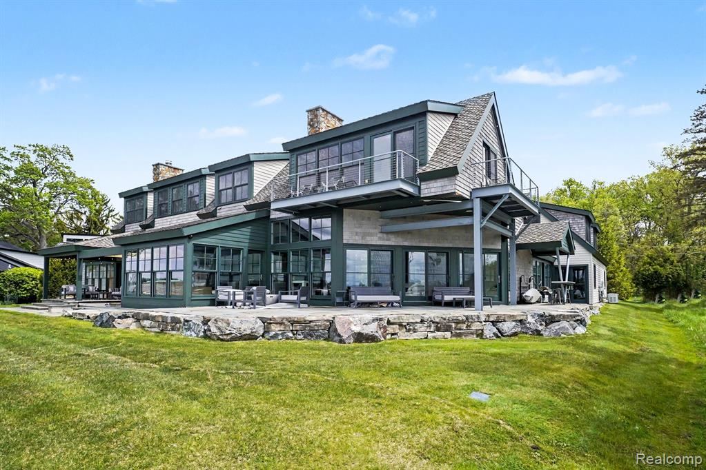 Exterior of the home with its stone-edged terrace and wide lawn