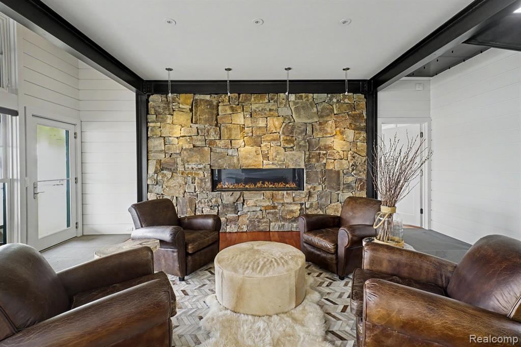 Living room with a stone fireplace and leather seating