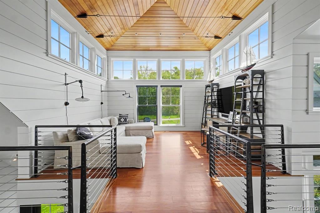 Upper living area with a vaulted wood ceiling and natural light