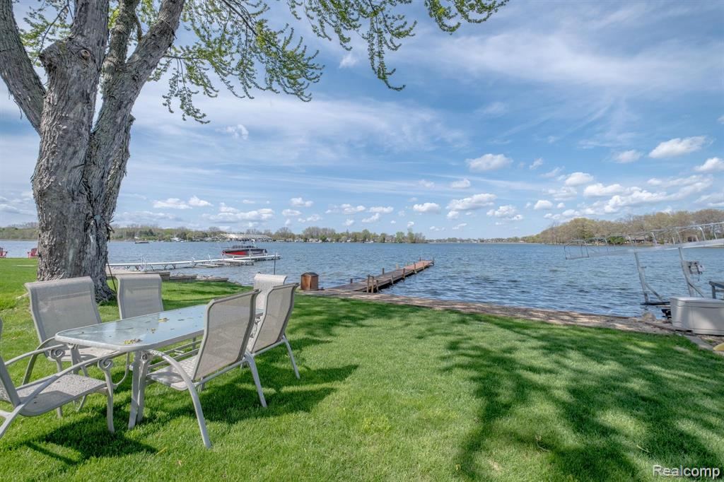 Grassy yard with a water view and boat dock